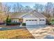 Gray two-story house with double garage and landscaped lawn at 7324 Friar Tuck Ln, Mint Hill, NC 28227