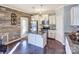 Modern kitchen with white cabinets, granite island, and stainless steel appliances at 7324 Friar Tuck Ln, Mint Hill, NC 28227