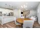 Kitchen and dining area with light hardwood floors and round table at 112 Atterberry Aly, Charlotte, NC 28217