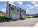 Attached garage with white doors and view of the surrounding neighborhood at 112 Atterberry Aly, Charlotte, NC 28217