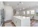 Open concept kitchen with island, white cabinets, and hardwood floors at 112 Atterberry Aly, Charlotte, NC 28217