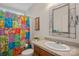 Bathroom with multicolored shower curtain and updated vanity at 115 Hawk Run Ln, Troutman, NC 28166