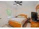 Bright bedroom with wood frame bed and ceiling fan at 115 Hawk Run Ln, Troutman, NC 28166