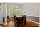 Dining area with hardwood floors and large window at 115 Hawk Run Ln, Troutman, NC 28166