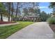 Ranch home with paved driveway and mature trees at 115 Hawk Run Ln, Troutman, NC 28166