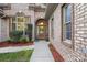 Inviting front entry with brick facade and landscaping at 115 Hawk Run Ln, Troutman, NC 28166