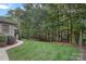 Landscaped backyard with lush greenery and wooded privacy at 115 Hawk Run Ln, Troutman, NC 28166