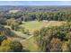 Aerial view of lush land with mature trees and a long driveway leading to a house at 13079 Philadelphia Church Rd, Oakboro, NC 28129