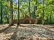 Exterior view of a wooden outbuilding, surrounded by mature trees and natural foliage in a wooded setting at 13079 Philadelphia Church Rd, Oakboro, NC 28129