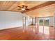 Bright living room with hardwood floors, wood ceiling, and plenty of natural light at 13079 Philadelphia Church Rd, Oakboro, NC 28129