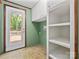 Mud room featuring tile floor, built-in storage and shelving, with a door to the exterior deck at 13079 Philadelphia Church Rd, Oakboro, NC 28129