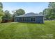 Back exterior showing the manicured yard and rear of the home, perfect for outdoor activities and relaxation at 337 Autumn Dr, Harrisburg, NC 28075