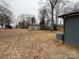 View of the home's backyard featuring a large, grassy area and a convenient storage shed at 337 Autumn Dr, Harrisburg, NC 28075