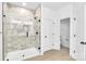 Modern bathroom with tiled shower and glass door, with neutral colors and modern fixtures at 337 Autumn Dr, Harrisburg, NC 28075