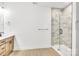 Modern bathroom featuring a glass-enclosed shower with stylish tile work, vanity sink, and hardwood-style floors at 337 Autumn Dr, Harrisburg, NC 28075