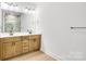 Modern bathroom featuring double vanity, large mirror, updated fixtures and a shower with glass surround at 337 Autumn Dr, Harrisburg, NC 28075