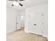 Bedroom featuring a double door closet, ceiling fan, wood-look floors, and white walls at 337 Autumn Dr, Harrisburg, NC 28075