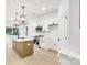 Well-lit kitchen with stainless steel appliances, pendant lights, and a kitchen island with sink at 337 Autumn Dr, Harrisburg, NC 28075