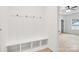 Mudroom with a bench, hooks, shelving, and wood-look flooring at 337 Autumn Dr, Harrisburg, NC 28075