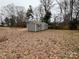 Exterior view of a gray backyard shed with double doors and black shutters at 337 Autumn Dr, Harrisburg, NC 28075