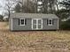 Exterior view of a gray backyard shed with double doors and black shutters at 337 Autumn Dr, Harrisburg, NC 28075