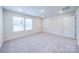 Well-lit bedroom with carpeted floors and a door at 34 Porter Nw St # Sw34, Concord, NC 28027