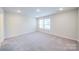 Bright bedroom with carpeted floors and two windows at 34 Porter Nw St # Sw34, Concord, NC 28027