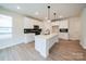 Modern kitchen featuring white cabinets, quartz countertops, and a large island at 34 Porter Nw St # Sw34, Concord, NC 28027