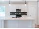 Modern kitchen with white cabinets, quartz countertops and geometric backsplash at 34 Porter Nw St # Sw34, Concord, NC 28027