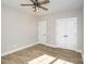 Neutral bedroom with wood floor, ceiling fan, and closet with double doors at 1025 Readsboro Dr # 11, Mt Ulla, NC 28125