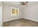 Bright bedroom with hardwood flooring, a ceiling fan, and natural light from a large window at 1025 Readsboro Dr # 11, Mt Ulla, NC 28125