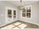 Well-lit dining room with modern lighting, and access to an outdoor space through french doors at 1025 Readsboro Dr # 11, Mt Ulla, NC 28125