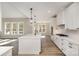 Bright and spacious kitchen featuring an island, white cabinets, modern appliances, and hardwood floors at 1025 Readsboro Dr # 11, Mt Ulla, NC 28125