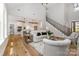 Open-concept living space featuring hardwood floors, a staircase, and a seamless transition to the kitchen at 1025 Readsboro Dr # 11, Mt Ulla, NC 28125