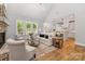 Bright and airy living room with large windows, modern decor, a brick fireplace, and an open-concept layout at 1025 Readsboro Dr # 11, Mt Ulla, NC 28125