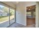 Bright sunroom with a sliding glass door and hardwood floors that leads to a room with carpet at 1111 Constitution Park Blvd, Rock Hill, SC 29732