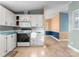 White cabinets and a black stove are featured in this kitchen with light flooring at 1812 Shearers Rd, Davidson, NC 28036