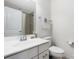 Clean bathroom with a white vanity, a framed mirror, and essential fixtures for everyday use at 2446 Alyssa Ln, Charlotte, NC 28208