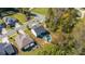 Aerial view of a home with a pool and patio in a wooded neighborhood at 2657 Cheverny Pl, Concord, NC 28027