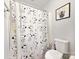 Quirky bathroom featuring a Peanuts-themed shower curtain and classic white fixtures at 2657 Cheverny Pl, Concord, NC 28027