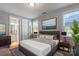 Bedroom with ensuite bathroom, decorative accents, a large painting, and neutral colors at 2657 Cheverny Pl, Concord, NC 28027