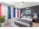Bedroom with a large painting, modern light fixtures, and blue accents at 2657 Cheverny Pl, Concord, NC 28027