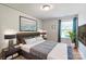 Bedroom featuring a large painting, modern light fixtures, and neutral colors at 2657 Cheverny Pl, Concord, NC 28027