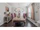 Elegant dining room featuring a chandelier, stylish decor, and ample natural light at 2657 Cheverny Pl, Concord, NC 28027