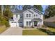 Charming two-story home with a stone accent, two-car garage, and well-manicured lawn at 2657 Cheverny Pl, Concord, NC 28027