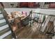 A foyer with an open view to the living room and dining room, featuring hardwood floors, wrought iron, and a dark grey couch at 2657 Cheverny Pl, Concord, NC 28027