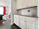 Bright kitchenette featuring white cabinets, granite countertops, and modern finishes at 2657 Cheverny Pl, Concord, NC 28027