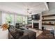 Cozy living room with a fireplace, built-in shelves, and a comfortable sectional sofa at 2657 Cheverny Pl, Concord, NC 28027