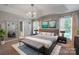 Main bedroom featuring a tray ceiling, a chandelier, a decorative mirror and ensuite bathroom at 2657 Cheverny Pl, Concord, NC 28027