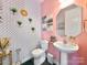 Stylish powder room featuring pink walls, patterned wallpaper, and elegant fixtures at 2657 Cheverny Pl, Concord, NC 28027